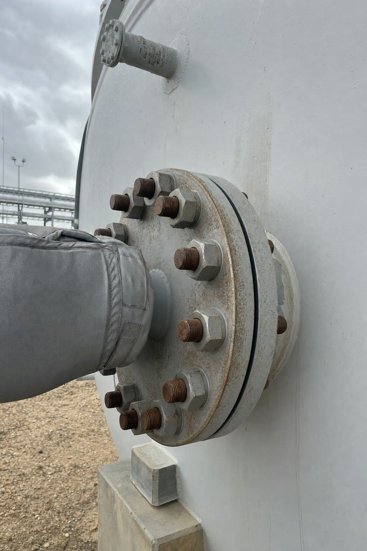 Phone camera framing the bolted nozzle flange of separator V-310