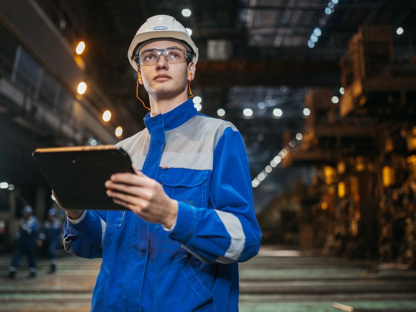 Inspector using a tablet on a plant floor