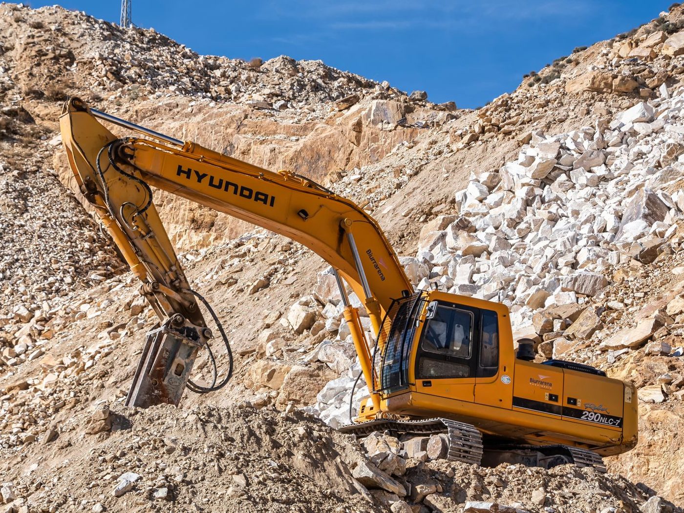 Excavator working in an open quarry
